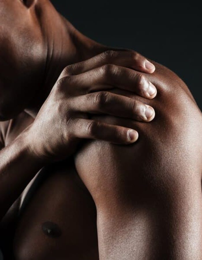 cropped-photo-young-shirtless-afro-american-man-with-shoulder-pain_171337-9259